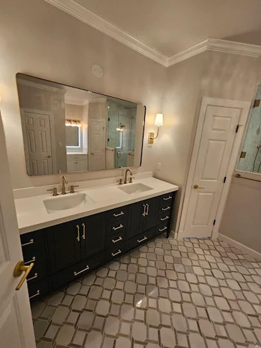 Modern bathroom with double sink vanity, large mirror, and elegant tile flooring.