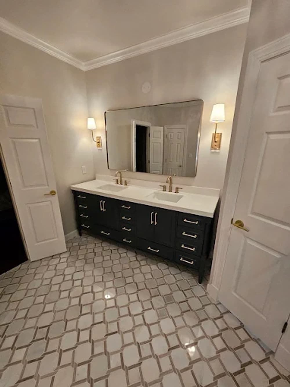 Modern bathroom with double vanity, elegant mirror, and stylish tile flooring.