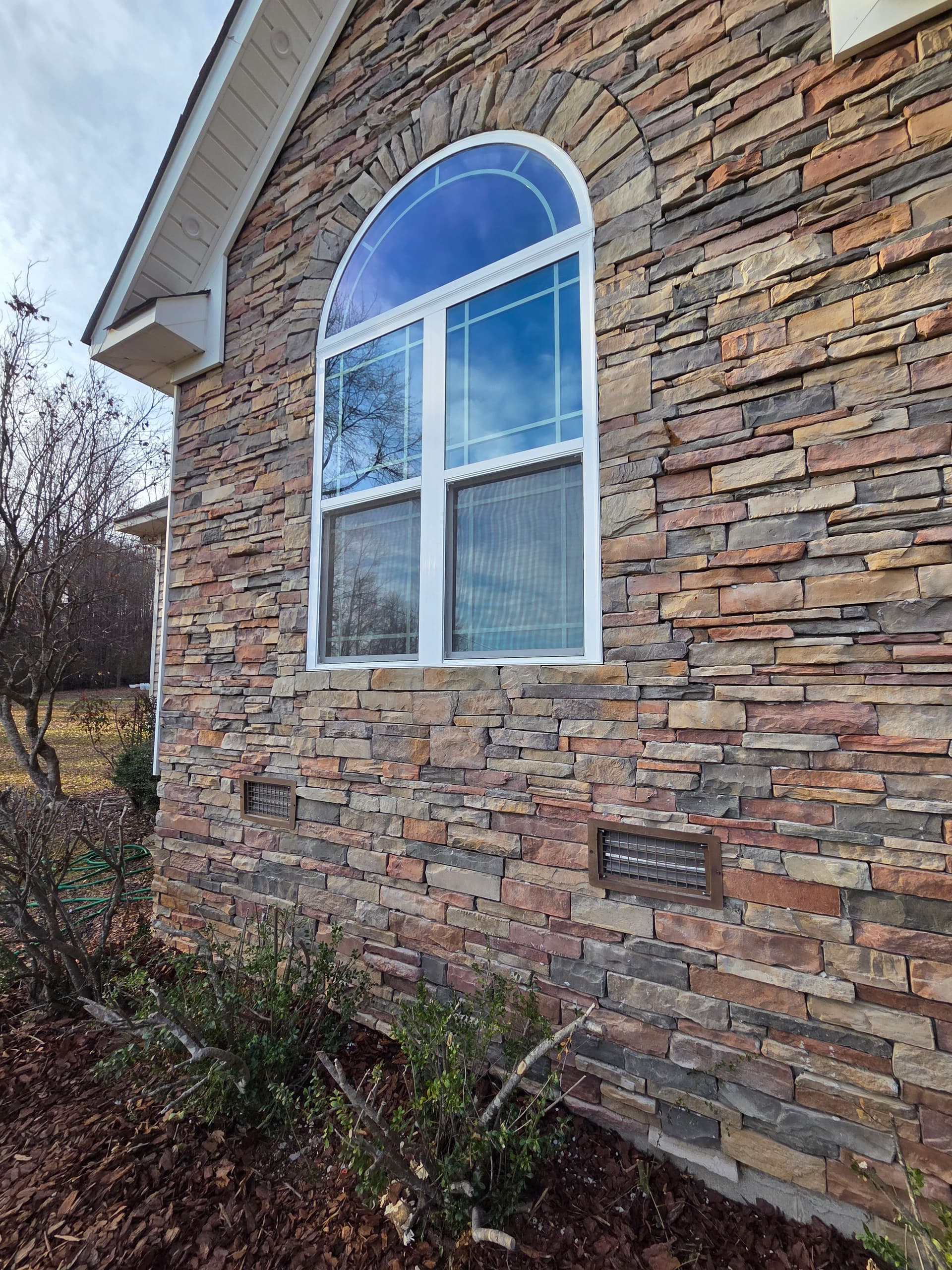 Elegant Stone Wall and Arched Window Home Update image